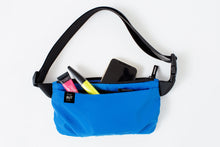 Load image into Gallery viewer, Sustainable Crossbody Bag in vibrant blue. Made from 100% GRS certified recycled polyester. Two separate zippered compartments holds all of your essentials.
